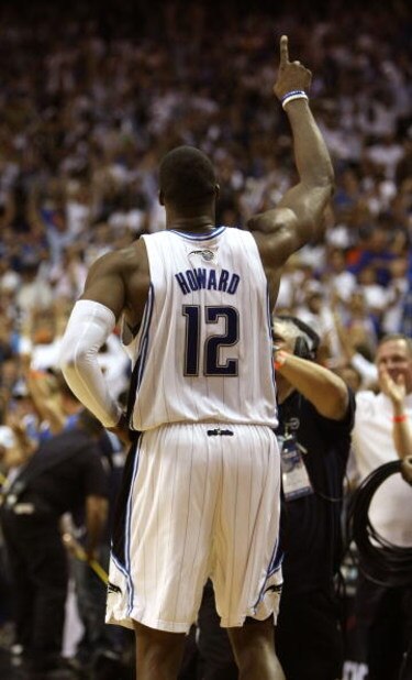 ORLANDO, FL - MAY 30: Dwight Howard #12 of the Orlando Magic celebrates on the court after defeating the Cleveland Cavaliers in Game Six of the Eastern Conference Finals during the 2009 Playoffs at Amway Arena on May 30, 2009 in Orlando, Florida. NOTE TO