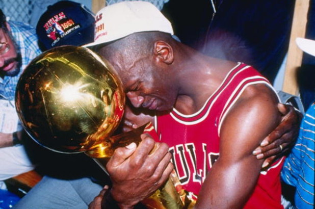 Jun 1991:  Series MVP and guard Michael Jordan of the Chicago Bulls hugs the championship trophy while surrounded by his father and wife after the Bulls defeated the Los Angeles Lakers four games to one in the series at the Great Western Forum in Inglewoo