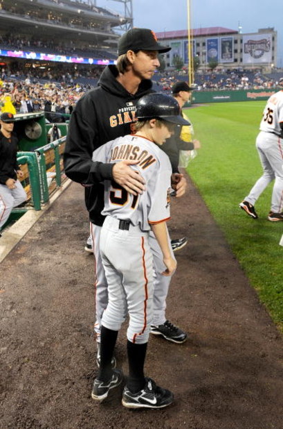 WASHINGTON - JUNE 04:  Randy Johnson #51 of the San Francisco Giants celebrates with his son Tanner after winning his 300th career game against the Washington Nationals at Nationals Park on June 4, 2009 in Washington, DC.  The Giants won the game 5-1.  (P