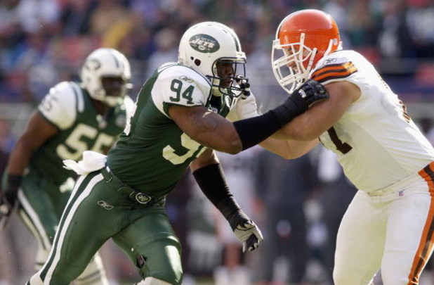 EAST RUTHERFORD, NJ - OCTOBER 27:  John Abraham #94 of the New York Jets tries to get past Ross Verba #77 of the Cleveland Browns during the game at Giant Stadium on October 27, 2002 in East Rutherford, New Jersey. The Browns won 24-21. (Photo by Ezra Sha