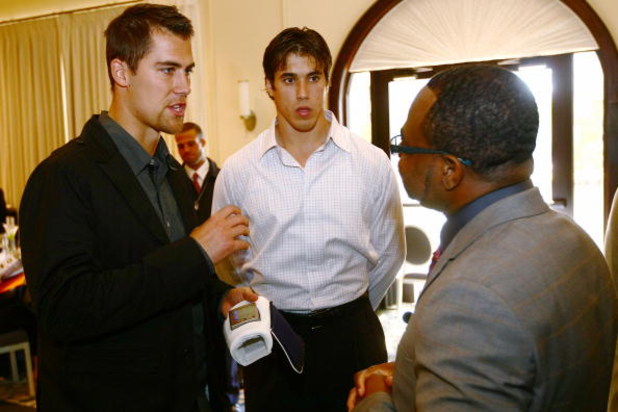 TAMPA, FL - JANUARY 31: Matt Cassel (L) and  Brady Quinn listen to ID Coach inventor Isaac Daniel at the launch of the Isaac Daniel, ID Coach at the Sheraton Riverwalk on January 31, 2009 in Tampa, Florida. The ID Coach system allows coaches to communicat
