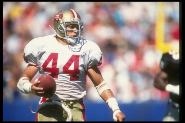 14 Oct 1990:  Running back Tom Rathman of the San Francisco 49ers moves the ball during a game against the Atlanta Falcons at the Fulton County Stadium in Atlanta, Georgia.  The 49ers won the game, 45-35. Mandatory Credit: Mike Powell  /Allsport