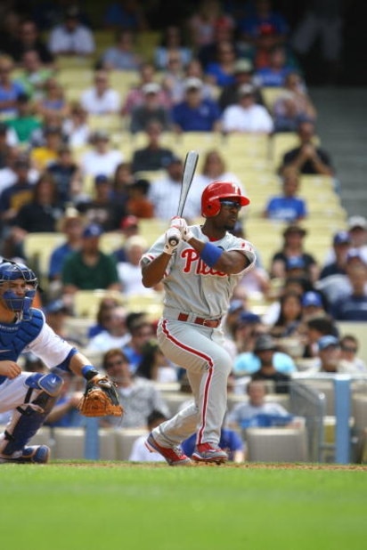 LOS ANGELES, CA - JUNE 06: Jimmy Rollins #11 of the Philadelphia Phillies swings at a pitch and runs to first base during the game against the Los Angeles Dodgers at Dodger Stadium on June 6, 2009 in Los Angeles, California. The Dodgers defeated the Phil