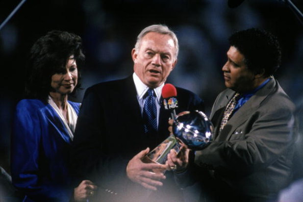 TEMPE, AZ - JANUARY 28:  Owner Jerry Jones of the Dallas Cowboys holds the Lombardi Trophy as he talks with sports commentator Greg Gumbel after Super Bowl XXX against the Pittsburgh Steelers at Sun Devil Stadium on January 28, 1996 in Tempe, Arizona.  Th