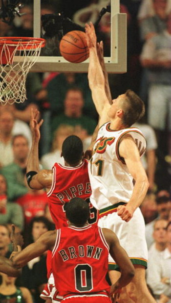 14 Jun 1996: Detlef Schrempf of the Seattle Supersonics blocks a shot by Scottie Pippen of the Chicago Bulls with Randy Brown #0 watching from the floor as the Sonics win game five of the NBA Finals over the Bulls by 89-78 at Key Arena in Seattle, Washing