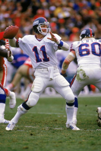 SAN FRANCISCO - DECEMBER 29:  Quarterback Phil Simms #11 of the New York Giants passes against the San Francisco 49ers during the NFC Divisional Playoff game at Candlestick Park on December 29, 1984 in San Francisco, California.  The 49ers won 21-10.  (Ph
