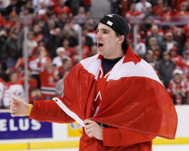 OTTAWA, ON - JANUARY 5: John Tavares #19 of Team Canada skates with a Canadian flag wrapped around him during post game ceremonies after defeating Team Sweden at the Gold Medal Game of the IIHF World Junior Championships at Scotiabank Place on January 05