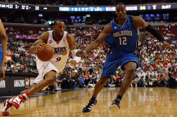 PHILADELPHIA - APRIL 26:  Andre Iguodala #9 of the Philadelphia 76ers drives against Dwight Howard #12 of the Orlando Magic during Game Four of the Eastern Conference Quarterfinals during the 2009 NBA Playoffs at the Wachovia Center on April 26, 2009 in P