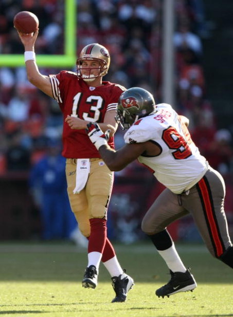 SAN FRANCISCO - DECEMBER 23:  Shaun Hill #13 of the San Francisco 49ers passes against Greg Spires #94 of the Tampa Bay Buccaneers during an NFL game at Monster Park December 23, 2007 in San Francisco, California.  (Photo by Jed Jacobsohn/Getty Images)