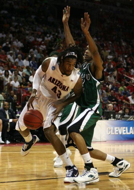 MIAMI - MARCH 22: Forward Jordan Hill #43 of the University of Arizona Wildcats is defended by forward George Tandy #21 of the Cleveland State University Vikings during the second round of the NCAA Division I Men's Basketball Tournament at the American