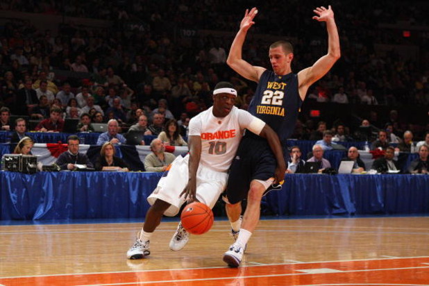NEW YORK - MARCH 13:  Jonny Flynn #10 of the Syracuse Orange dribbles against Alex Ruoff #22 of the West Virginia Mountaineers during the semifinal round of the Big East Tournament at Madison Square Garden on March 13, 2009 in New York City. (Photo by Jim