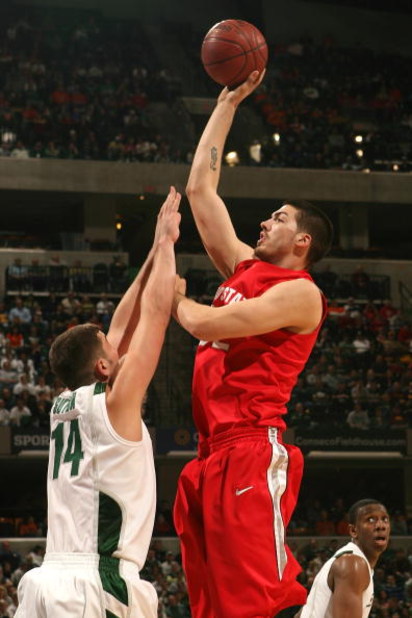 INDIANAPOLIS - MARCH 14:  B.J. Mullens #32 of the Ohio State Buckeyes attempts a shot against Goran Suton #14 of the Michigan State Spartans during their semifinal game of the Big Ten Men's Basketball Tournament at Conseco Fieldhouse on March 14, 2009 in 