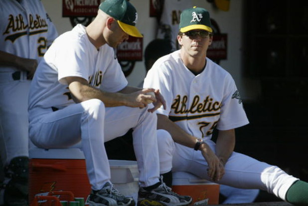 OAKLAND, CA - OCTOBER 6:  Tim Hudson #15 and Barry Zito #75 of the Oakland Athletics watch from the dugout during game five of the American League Western Division Series against the Minnesota Twins at Network Associates Coliseum on October 6, 2002 in Oak