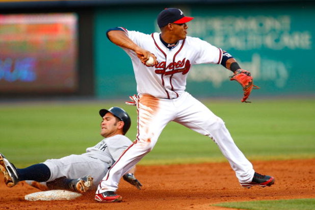 ATLANTA - JUNE 25:  Yunel Escobar #19 of the Atlanta Braves attempts to turn a double play as Johnny Damon #18 of the New York Yankees slides into second base at Turner Field on June 25, 2009 in Atlanta, Georgia.  (Photo by Kevin C. Cox/Getty Images)