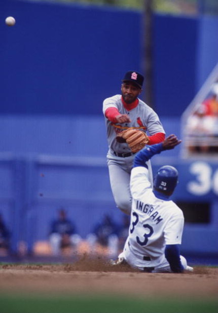 14 MAY 1995:  OZZIE SMITH, SHORTSTOP FOR THE ST. LOUIS CARDINALS, THROWS TO FIRST IN AN ATTEMPTED DOUBLE PLAY AS GAREY INGRAM OF THE LOS ANGELES DODGERS SLIDES IN TO SECOND BASE DURING THE CARDINALS'' 6-5 WIN IN 11 INNINGS AT DODGER STADIUM IN LOS ANGELES