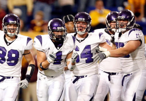 MINNEAPOLIS - NOVEMBER 01:  Brendan Smith #4 of the Northwestern Wildcats celebrates his interception for a touchdown in the final minute of the game with Brian Peters #38, Doug Bartels #64 and Al Netter #75 against the Minnesota Golden Gophers during the