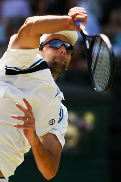 WIMBLEDON, ENGLAND - JULY 01: Ivo Karlovic of Croatia serves during the men's singles quarter final match against Roger Federer of Switzerland on Day Nine of the Wimbledon Lawn Tennis Championships at the All England Lawn Tennis and Croquet Club on July