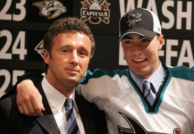VANCOUVER, BC - JUNE 24:  General manager Doug Wilson (L) of the San Jose Sharks poses with 16th overall pick Ty Wishart of the Sharks on stage during the 2006 NHL Draft held at General Motors Place on June 24, 2006 in Vancouver, Canada.  (Photo by Bruce 