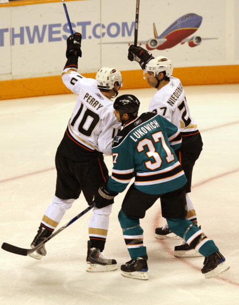 SAN JOSE, CA - APRIL 16:  Scott Niedermayer #27 of the Anaheim Ducks celebrates with teammate Corey Perry #10 after scoring as Brad Lukowich #37 of the San Jose Sharks looks on during Game One of the Western Conference Quarterfinals of the 2009 Stanley Cu