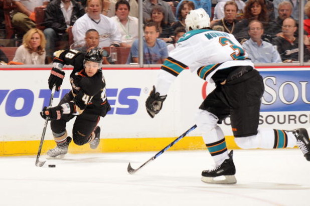 ANAHEIM, CA - APRIL 21:  Andrew Ebbett #48 of the Anaheim Ducks skates with the puck against Douglas Murray #3 of the San Jose Sharks during Game Three of the Western Conference Quarterfinal Round of the 2009 Stanley Cup Playoffs at Honda Center on April 