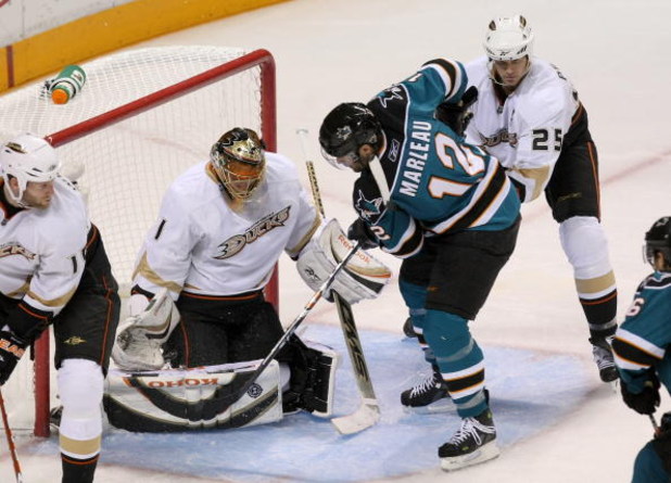 SAN JOSE, CA - APRIL 25:  Patrick Marleau #12 of the San Jose Sharks looks for the rebound just before scoring the game winning goal against goaltender Jonas Hiller #1 and Chris Pronger #25 of the Anaheim Ducks during Game Five of the Western Conference Q