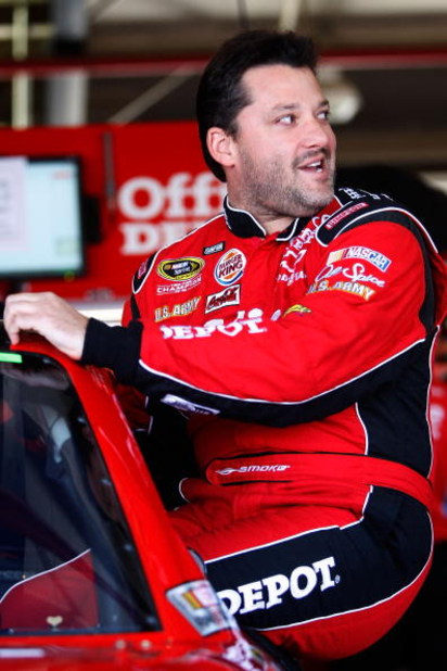 FONTANA, CA - OCTOBER 09:  Tony Stewart, driver of the #14 Office Depot/Old Spice Chevrolet, climbs into his car during practice for the NASCAR Sprint Cup Series Pepsi 500 at Auto Club Speedway on October 9, 2009 in Fontana, California.  (Photo by Chris G