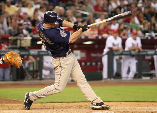 PHOENIX - MAY 25:  Kevin Kouzmanoff #5 of the San Diego Padres hits a RBI single against the Arizona Diamondbacks during the eighth inning of the major league baseball game at Chase Field on May 25, 2009 in Phoenix, Arizona.  (Photo by Christian Petersen/