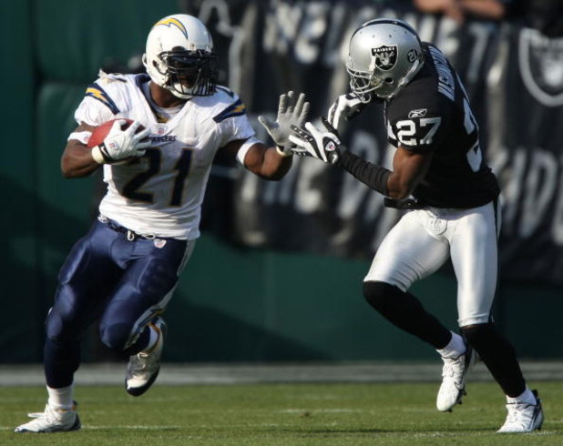 OAKLAND, CA - DECEMBER 30:  LaDainian Tomlinson #21 of the San Diego Chargers runs against Fabian Washington #27 of the Oakland Raiders during an NFL game on December 30, 2007 at McAfee Coliseum in Oakland, California.  (Photo by Jed Jacobsohn/Getty Image