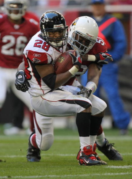 GLENDALE, AZ - DECEMBER 23:  Warrick Dunn #28 of the Atlanta Falcons is tackled by Karlos Dansby #58 of the Arizona Cardinals during the second quarter at University of Phoenix Stadium on December 23, 2007 in Glendale, Arizona.  The Cardinals won 30-27 in