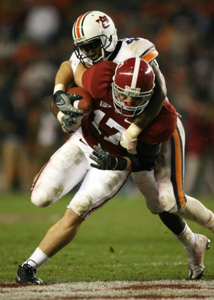 TUSCALOOSA, AL - NOVEMBER 29:  Tight end Brad Smelley #17 of the Alabama Crimson Tide is brought down by safety Zac Etheridge #4 of the Auburn Tigers at Bryant-Denny Stadium on November 29, 2008 in Tuscaloosa, Alabama. Alabama defeated Auburn 36-0.  (Phot