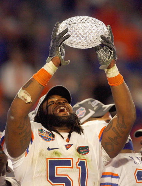 MIAMI - JANUARY 08:  Brandon Spikes #51 of the Florida Gators holds up the winning trophy after the FedEx BCS National Championship Game against the Oklahoma Sooners at Dolphin Stadium on January 8, 2009 in Miami, Florida.  (Photo by Eliot J. Schechter/Ge