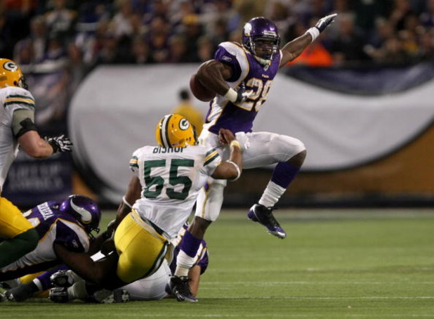 MINNEAPOLIS - NOVEMBER 09:  Running back Adrian Peterson #28 of the Minnesota Vikings carries the ball against linebacker Desmond Bishop #55 of the Green Bay Packers on November 9, 2008 at the Metrodome in Mineapolis, Minnesota.  (Photo by Stephen Dunn/Ge