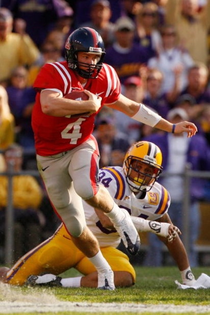 BATON ROUGE, LA - NOVEMBER 22: Quarterback Jevan Snead #4 of the Ole Miss Rebels scrambles after a missed tackle by Rahim Alem #84 of the Louisiana State University Tigers on November 22, 2008 at Tiger Stadium in Baton Rouge, Louisiana. (Photo by Chris