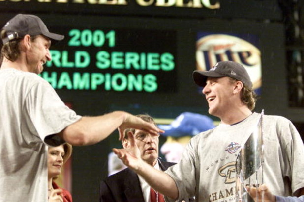 4 Nov 2001:  Co-MVP winners Curt Schilling #38 and Randy Johnson #51 of the Arizona Diamondbacks celebrate before being presented the MVP trophy by commissioner Bud Selig after winning the World Series over the New York Yankees at Bank One Ballpark in Pho