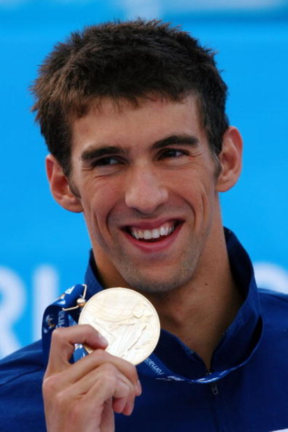 ROME - AUGUST 01:  Michael Phelps of the United States receives the gold medal during the medal ceremony for the Men's 100m Butterfly Final during the 13th FINA World Championships at the Stadio del Nuoto on August 1, 2009 in Rome, Italy.  (Photo by Clive