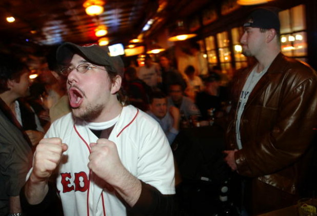 NEW YORK - OCTOBER 20:  Boston Red Sox fan Zalman Abranchik (L) celebrates while a Yankees fan stands stunned in the Amsterdam Inn in the Upper West Side October 20, 2004 in New York City.  (Photo by Chris Hondros/Getty Images)