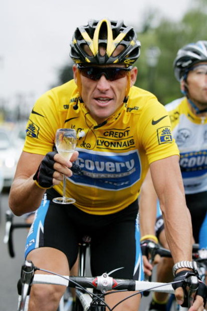 PARIS - JULY 24:  Lance Armstrong of the USA riding for the Discovery Channel team has a glass of champange on his way to winning a seventh consecutive Tour de France during Stage 21 of the Tour de France between Montereau and The Champs Elysees on July 2