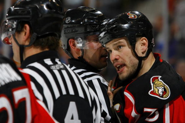 OTTAWA - FEBRUARY 19:  Jarkko Ruutu #73 of the Ottawa Senators has words with referee Wes McCauley #4  in a game against the Vancouver Canucks on February 19, 2009 at the Scotiabank Place in Ottawa, Canada. (Photo by Phillip MacCallum/Getty Images)