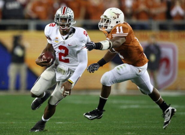 GLENDALE, AZ - JANUARY 05: Quarterback Terrelle Pryor #2 of the Ohio State Buckeyes scrambles with the ball past Jared Norton #11 of the Texas Longhorns during the Tostitos Fiesta Bowl Game on January 5, 2009 at University of Phoenix Stadium in Glendale,