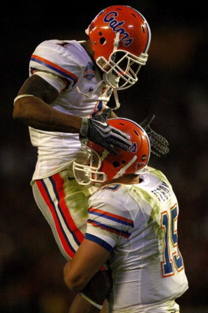 MIAMI - JANUARY 08: Quarterback Tim Tebow #15 of the Florida Gators celebrates after a touchdown with the Percy Harvin #1 against the Oklahoma Sooners in the FedEx BCS National Championship Game at Dolphin Stadium on January 8, 2009 in Miami, Florida. (