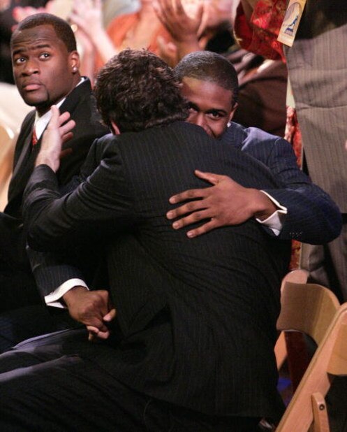 NEW YORK - DECEMBER 10: Heisman candidate quarterback Vince Young #10 (L) of the Texas Longhorns looks on as running back Reggie Bush #5 (R) of the USC Trojans embraces teammate and fellow Heisman candidate, quarterback Matt Leinart #11, after Bush was a