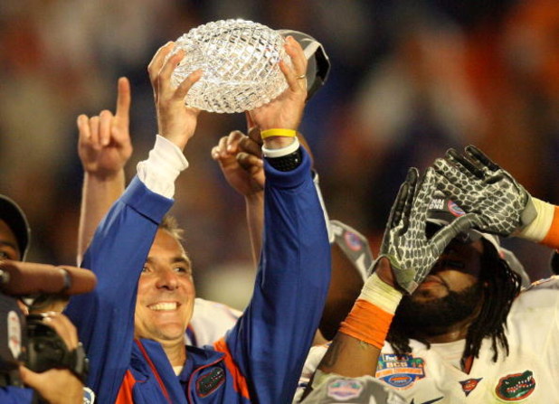 MIAMI - JANUARY 08: Head coach Urban Meyer of the Florida Gators celebrates with the National Championship trophy after therir 24-14 win against the Oklahoma Sooners during the FedEx BCS National Championship game at Dolphin Stadium on January 8, 2009 in