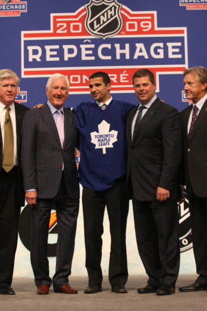 MONTREAL - JUNE 26:  (L-R)  Toronto Maple Leafs President & GM Brian Burke, Special Advisor Cliff Fletcher, First Round Draft Pick Nazem Kadri, Senior VP of Hockey Operations Dave Nonis and Head Coach Ron Wilson stand on the stage during the first round o