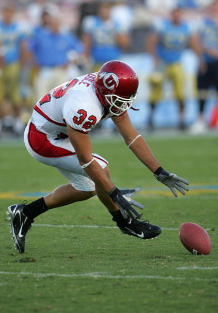 PASADENA, CA - SEPTEMBER 02:  Eric Weddle #32 of the Utah Utes dives for a loose ball against the UCLA Bruins during the college football game held on Septemeber 2, 2006 at the Rose Bowl in Pasadena, California. The Bruins defeated the Utes 31-10. The Bru