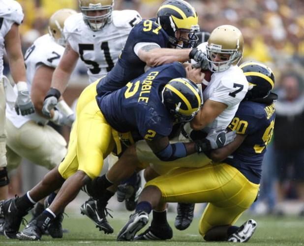 ANN ARBOR, MI - SEPTEMBER 15: Jimmy Clausen #7 of the Notre Dame Fighting Irish is sacked by Shawn Crable #2, Tim Jamison #90 and Will Johnson #97 of the  Michigan Wolverines at Michigan Stadium September 15, 2007 in Ann Arbor, Michigan. (Photo By Gregory