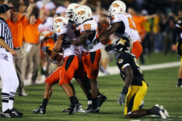 COLUMBIA, MO - OCTOBER 11:  Patrick Lavine #4 of the Oklahoma State Cowboys is greeted by teammates after making an interception in the closing seconds against the Missouri Tigers on October 11, 2008 at Memorial Stadium in Columbia, Missouri.  Oklahoma St