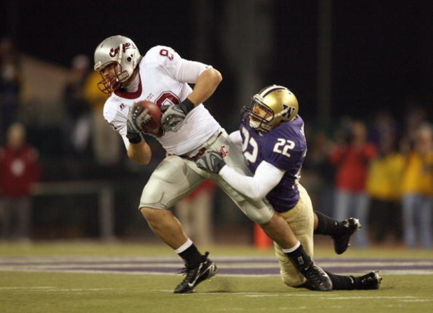 SEATTLE - NOVEMBER 24: Devin Frischknecht #80 of the Washington State Cougars carries the ball against E.J. Savannah #22 of the Washington Huskies during the 100th Apple Cup Game at Husky Stadium on November 24, 2007 in Seattle, Washington. (Photo by Otto