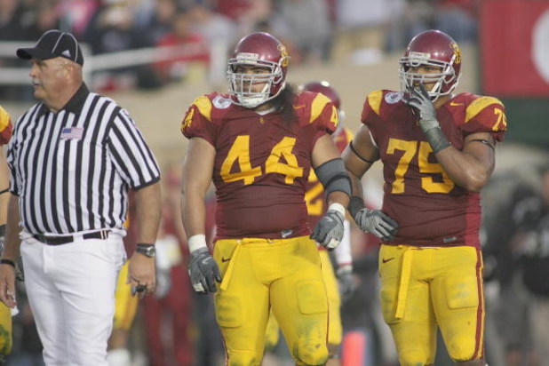 PASADENA, CA - JANUARY 1:  Christian Tupou #44 of the USC Trojans and Fili Moala #75 look on against the Penn State Nittany Lions on January 1, 2009 at the Rose Bowl in Pasadena, California.  USC won 38-24.  (Photo by Jeff Golden/Getty Images)
