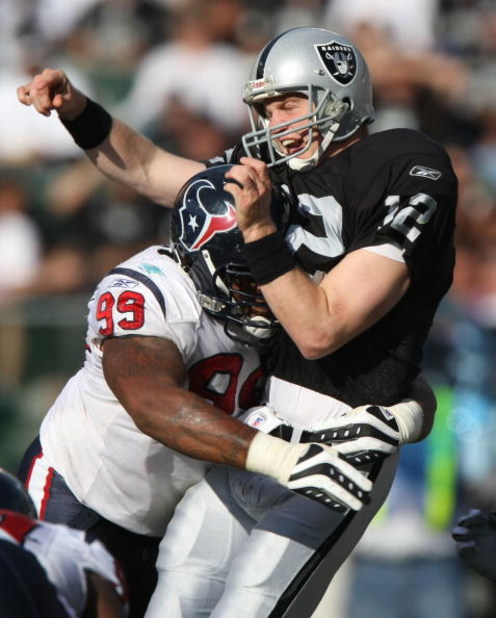 OAKLAND, CA - NOVEMBER 4: Travis Johnson #99 of the Houston hits quarterback Josh McCown #12 of the Oakland Raiders at McAfee Coliseum November 4, 2007 in Oakland, California.  (Photo by Jed Jacobsohn/Getty Images)