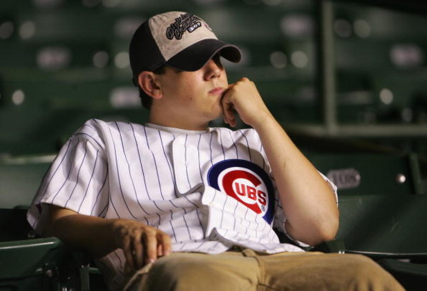 CHICAGO - OCTOBER 06:  A fan of the Chicago Cubs sits in the stands dejected after the Cubs lost 5-1 against the Arizona Diamondbacks during Game Three of the National League Divisional Series at Wrigley Field on October 6, 2007 in Chicago, Illinois. With